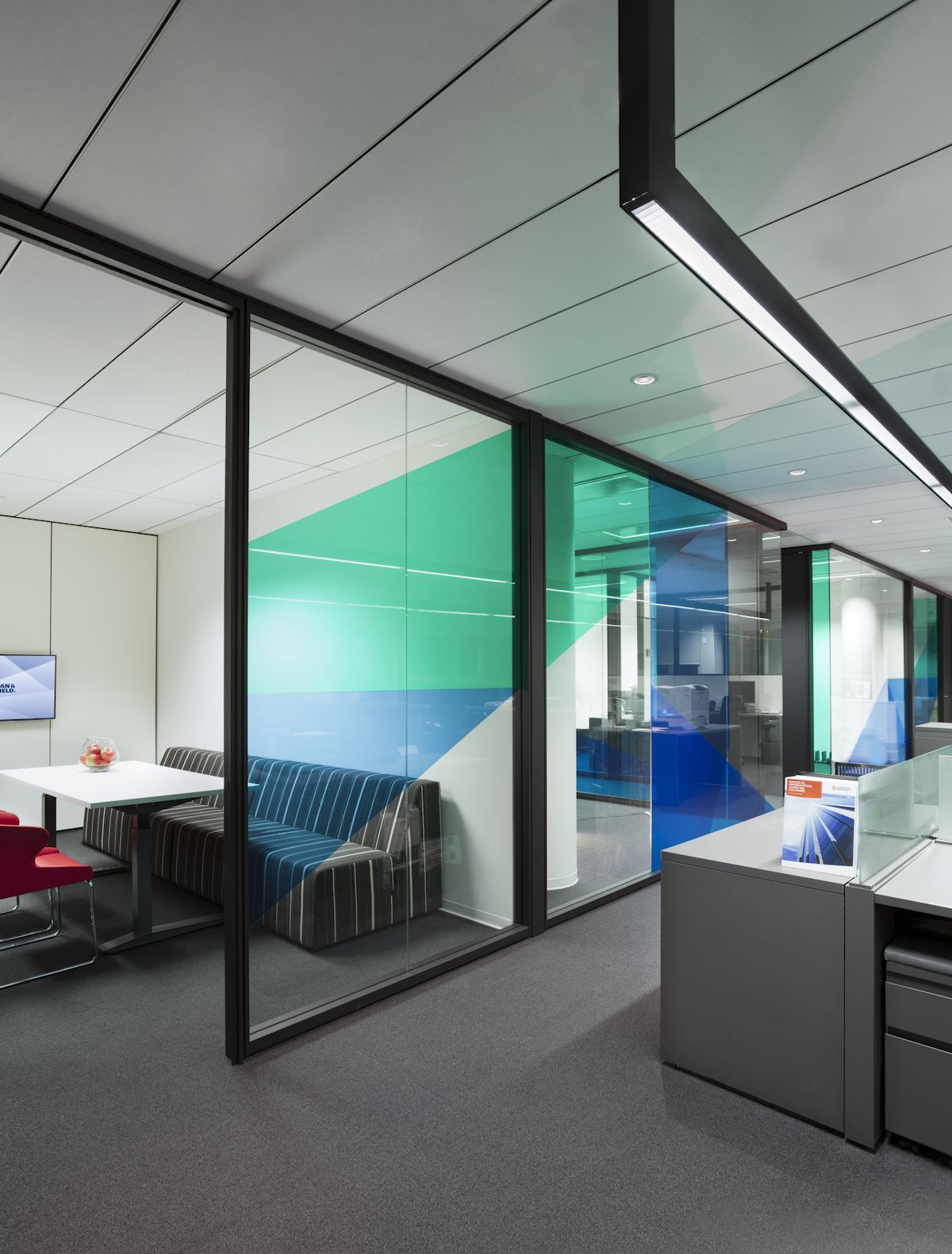 Office space using modular glass wall panels with black frames to create clean lines and let the light in