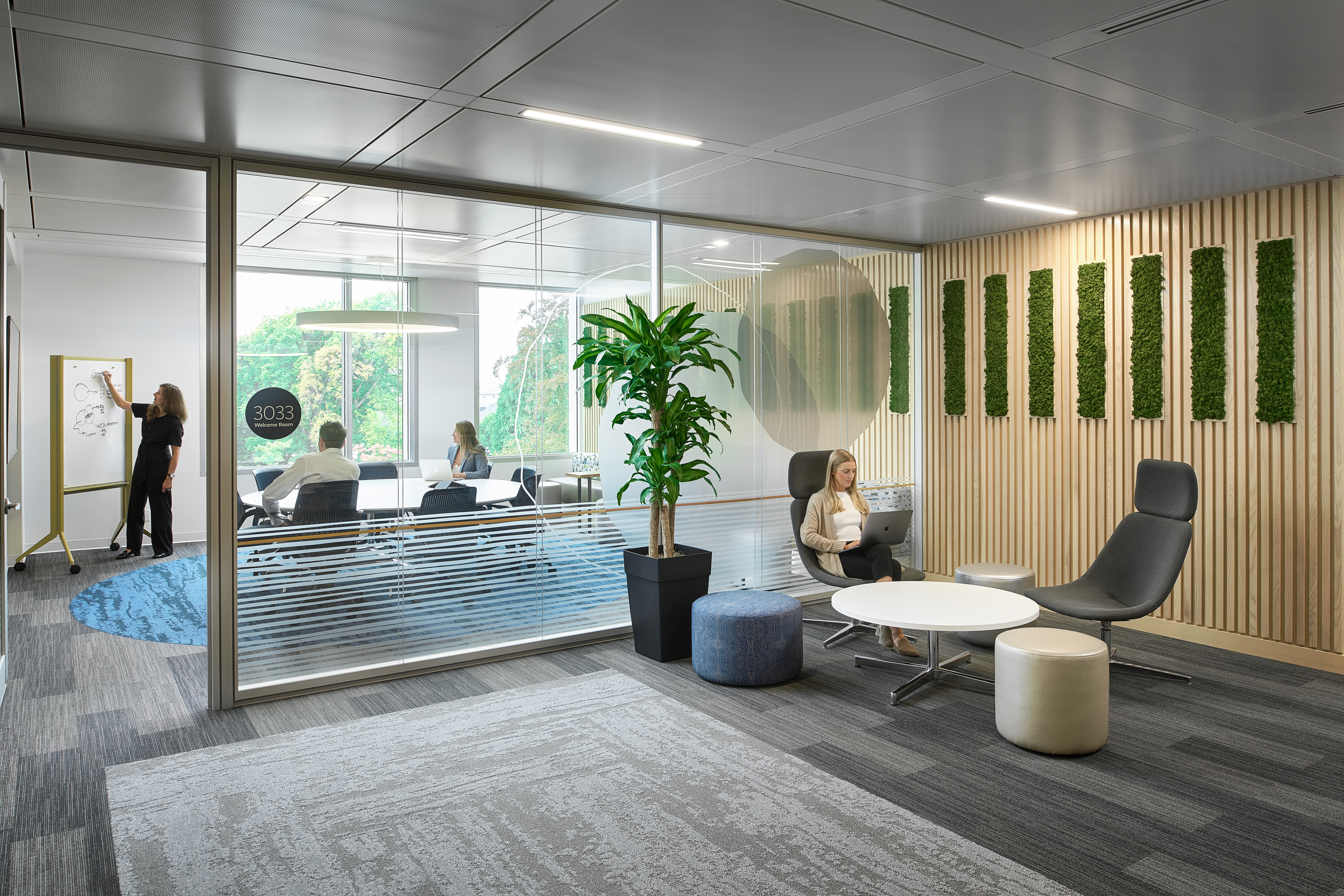Image of an office space and meeting room built using a modular double pane glass wall system