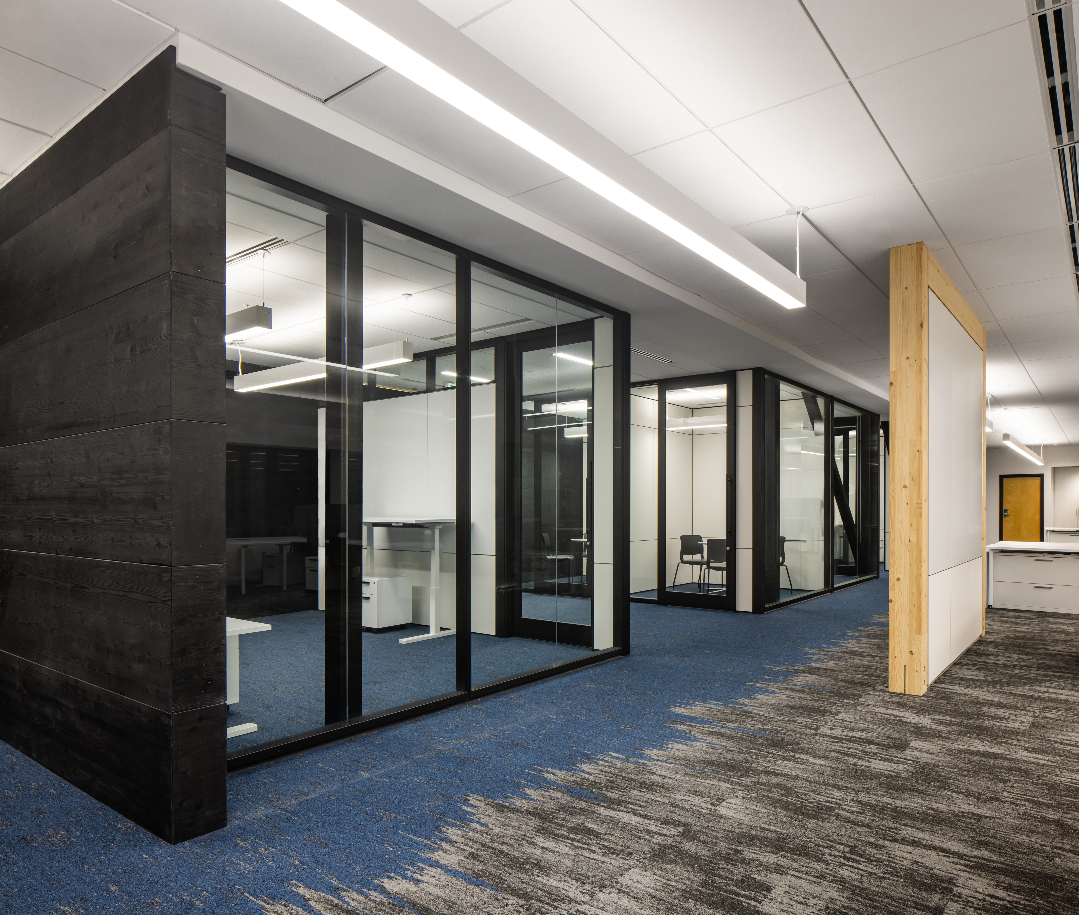 College breakout rooms made with prefab solid walls, writeable surfaces, and timber walls