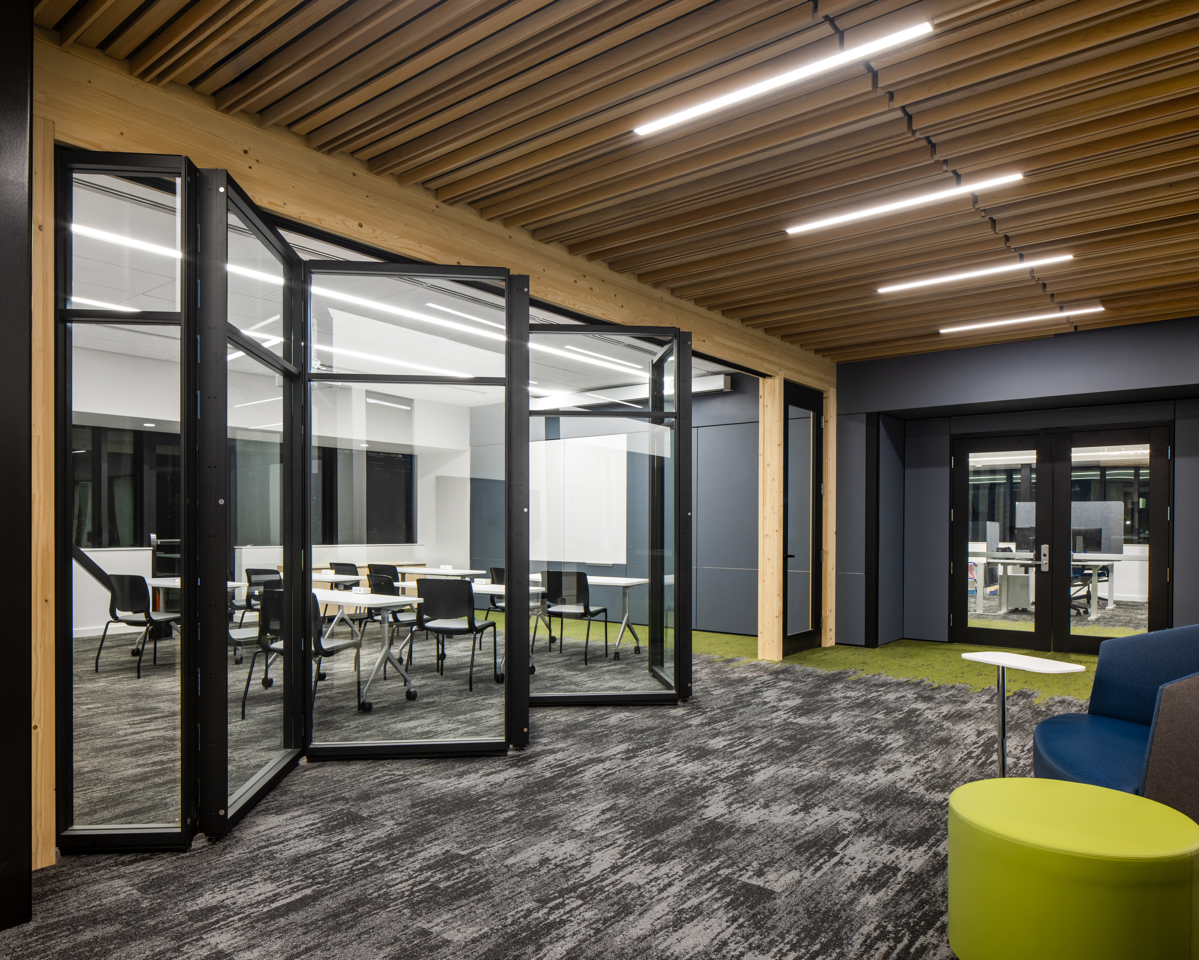 University student centre made with folding glass walls and overhead wood finishes