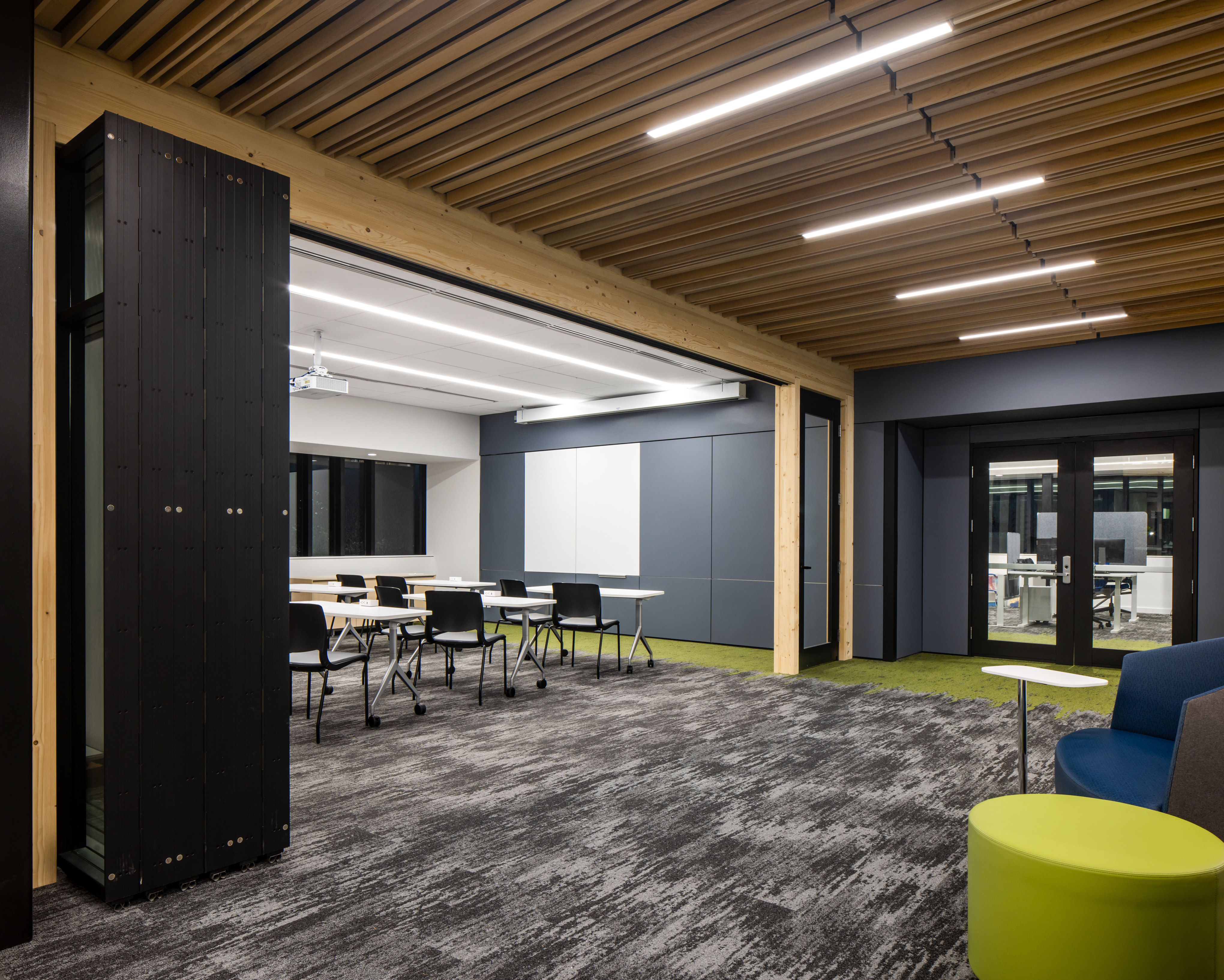Modern campus conference room with foldable glass doors under time ceiling