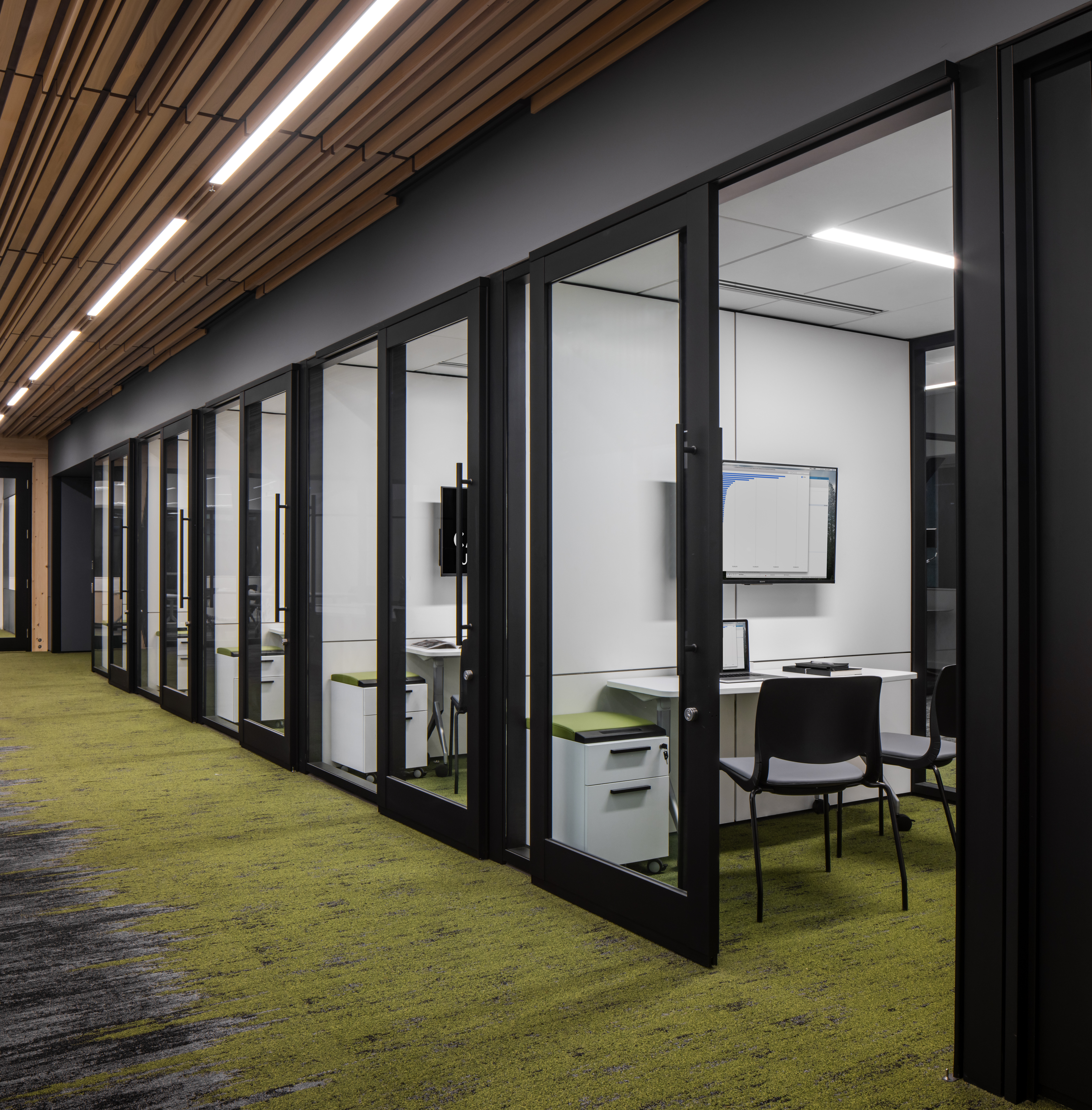 University student building with meeting spaces behind sliding glass walls and integrated technology