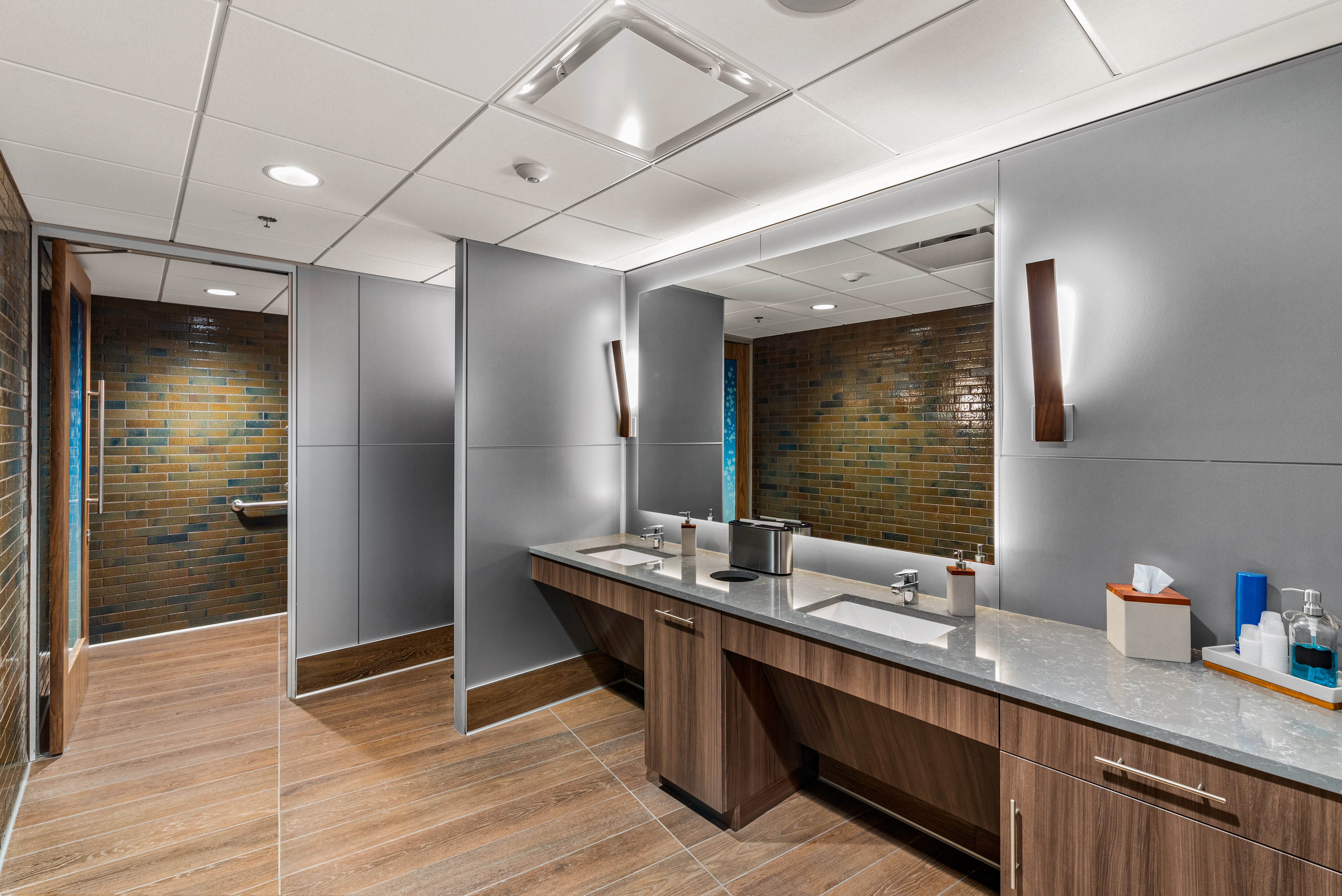 This washroom space has solid modular walls and custom casework cabinetry around the sink area.