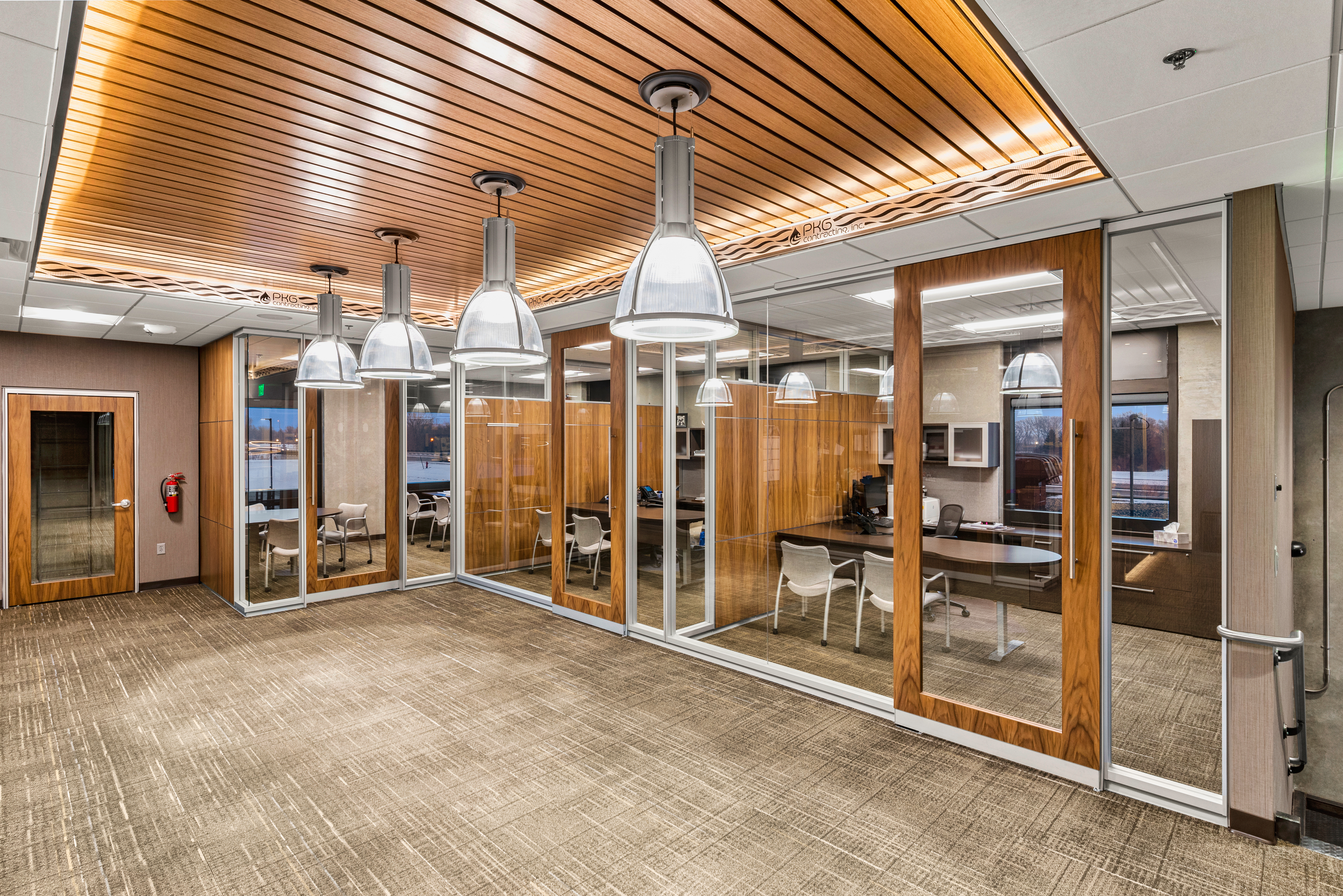 Private offices have been created with a combination of solid and glass modular walls. with sliding glass doors.