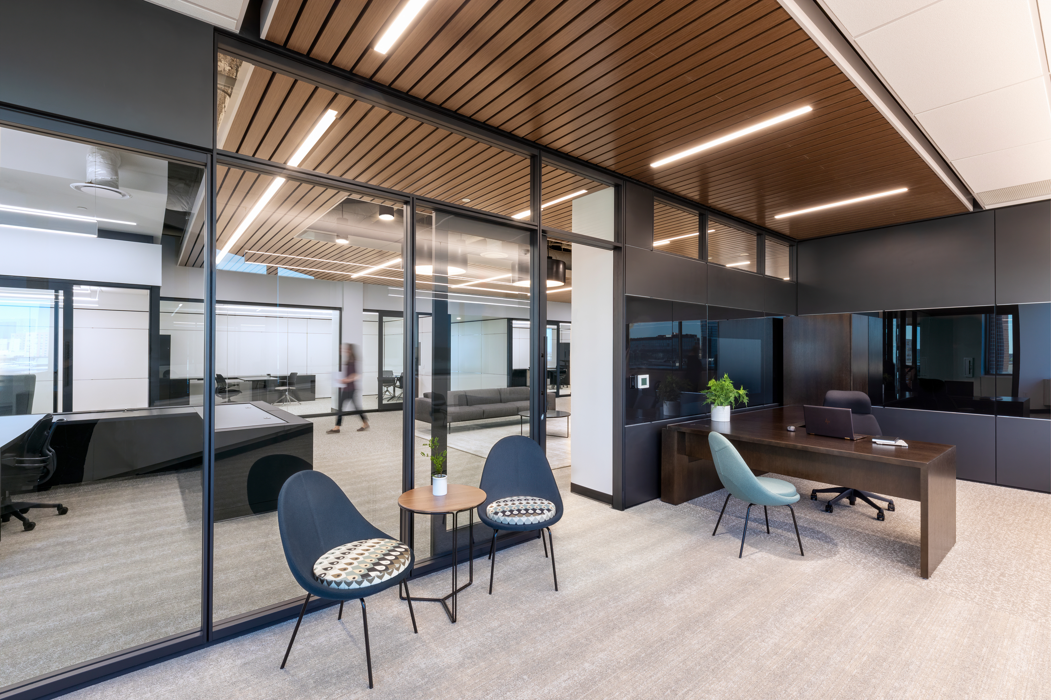 Inside this office we see DIRTT's solid, glass and combination walls with aluminum framed glass sliding door.