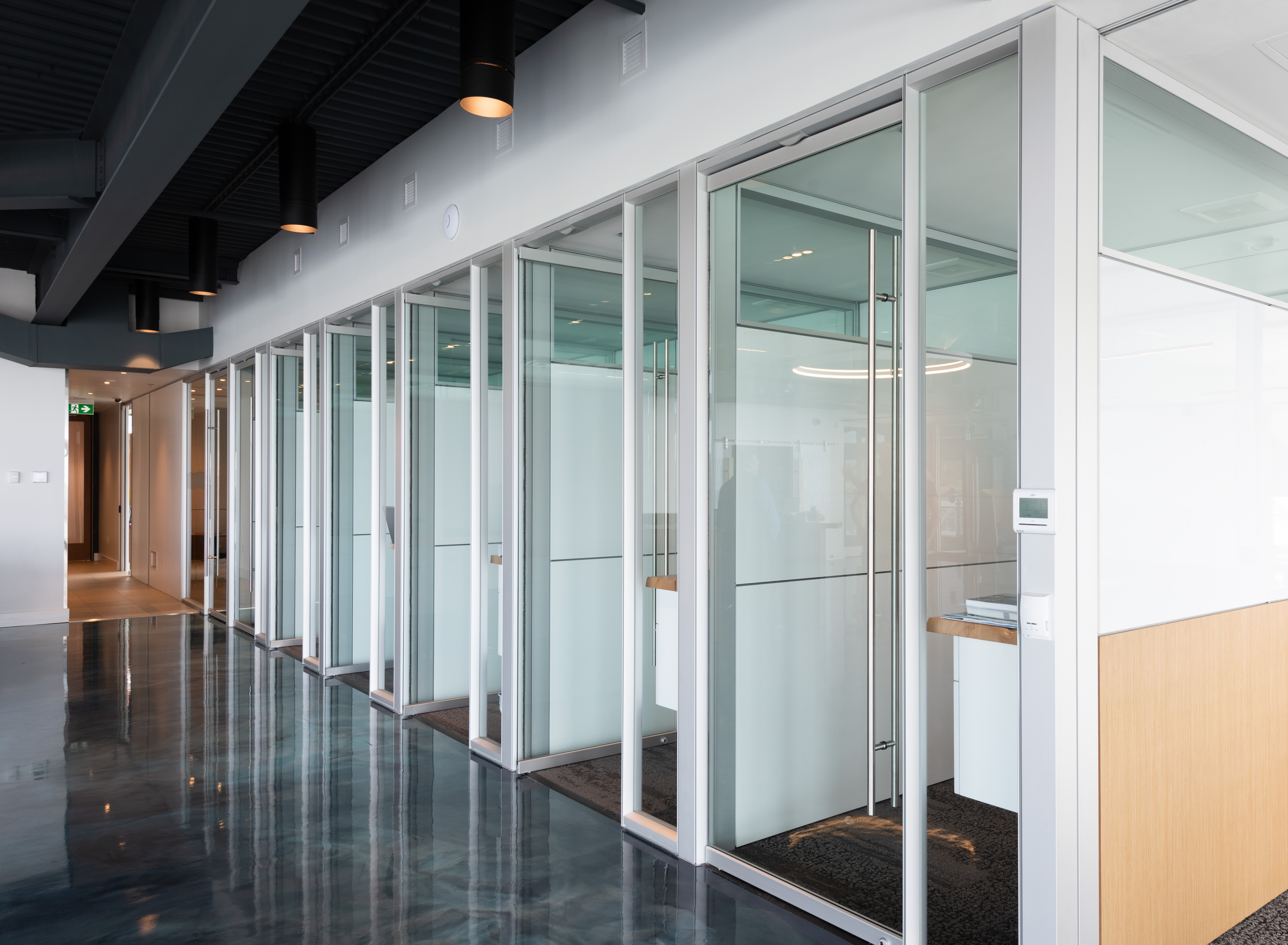 Image of modular solid and glass walls making up several private office spaces