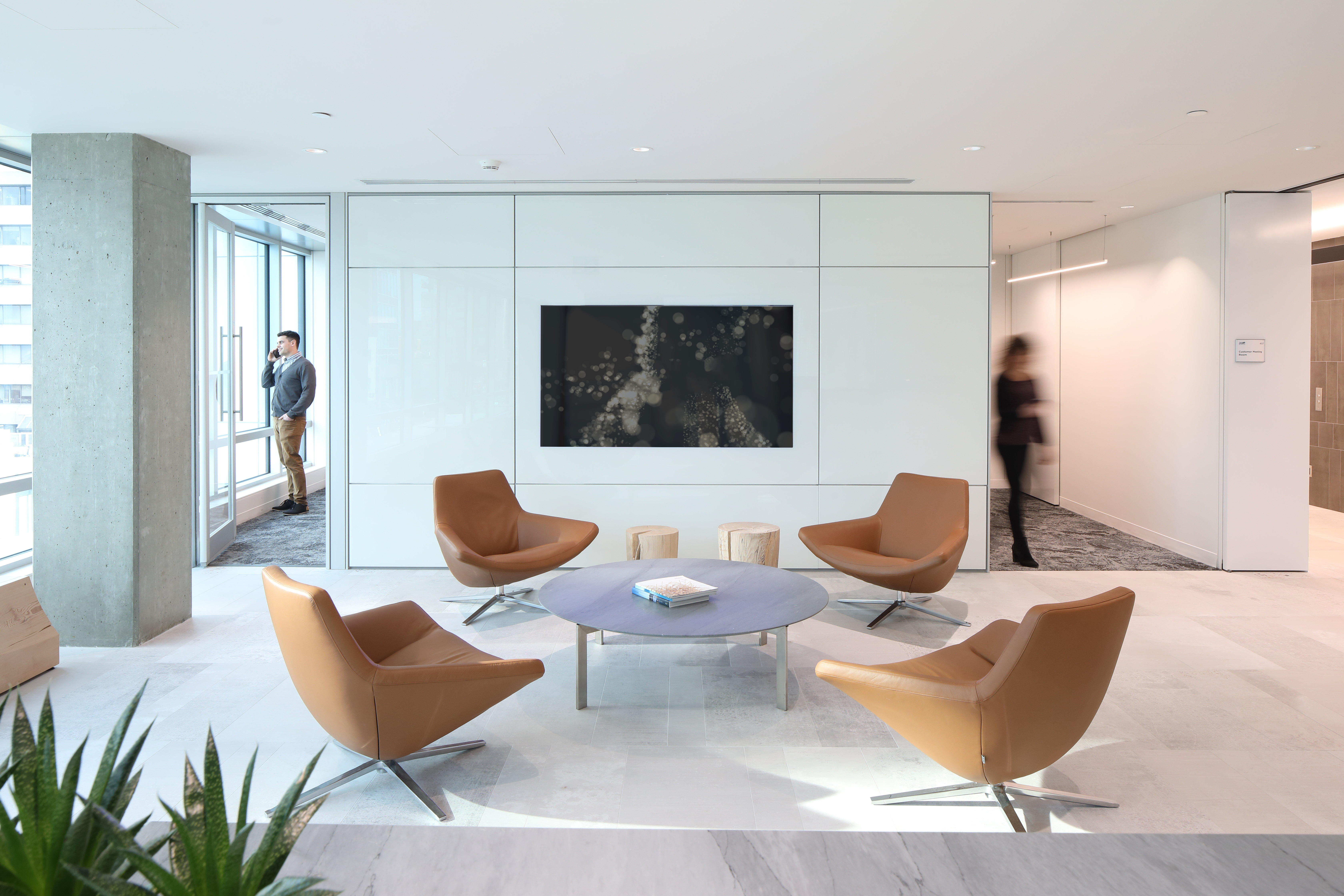Image of a office lounge area built with prefab modular solid walls panels and integrated technology in the wall