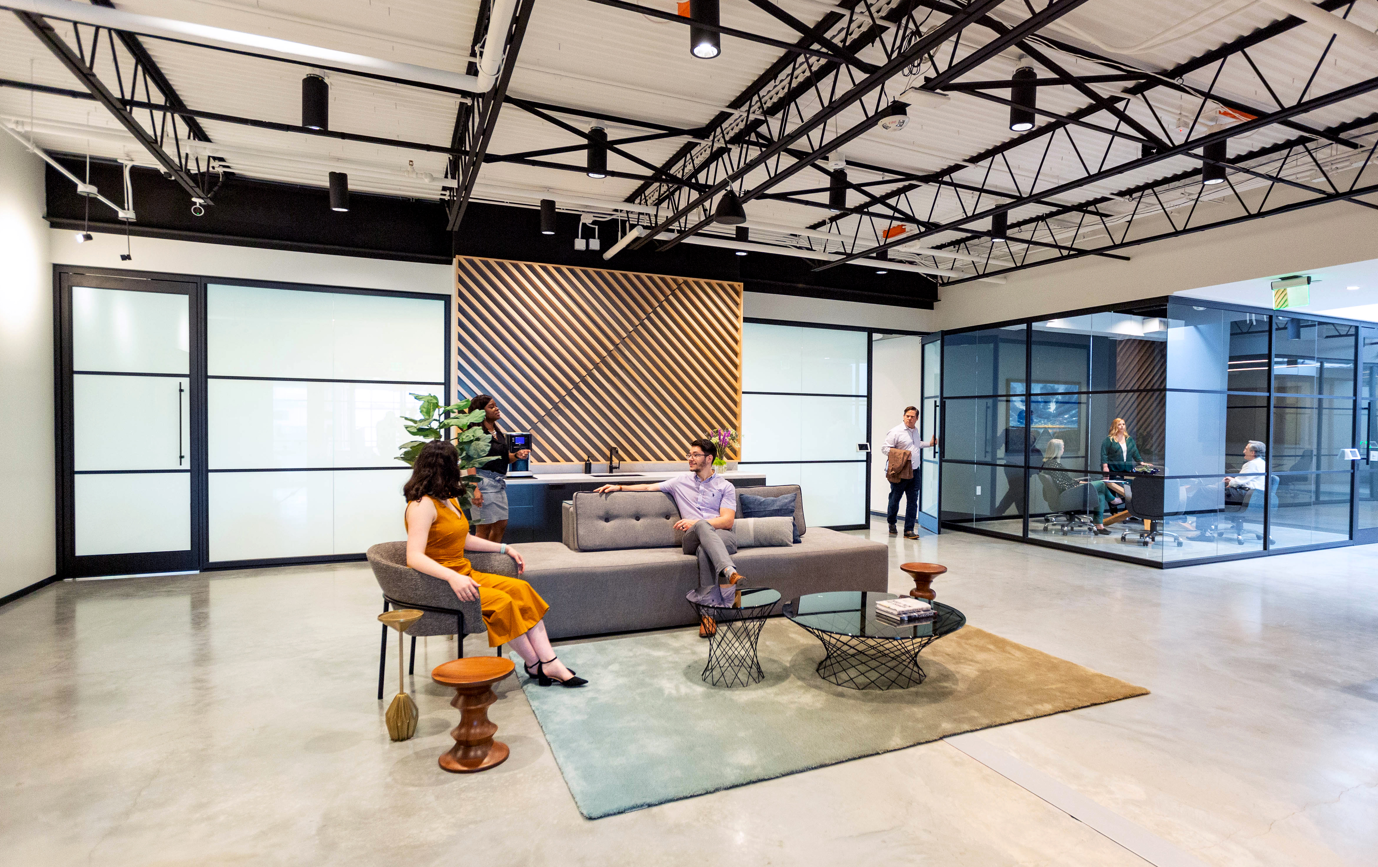 Bright and open office space with modular glass walls dividing the space