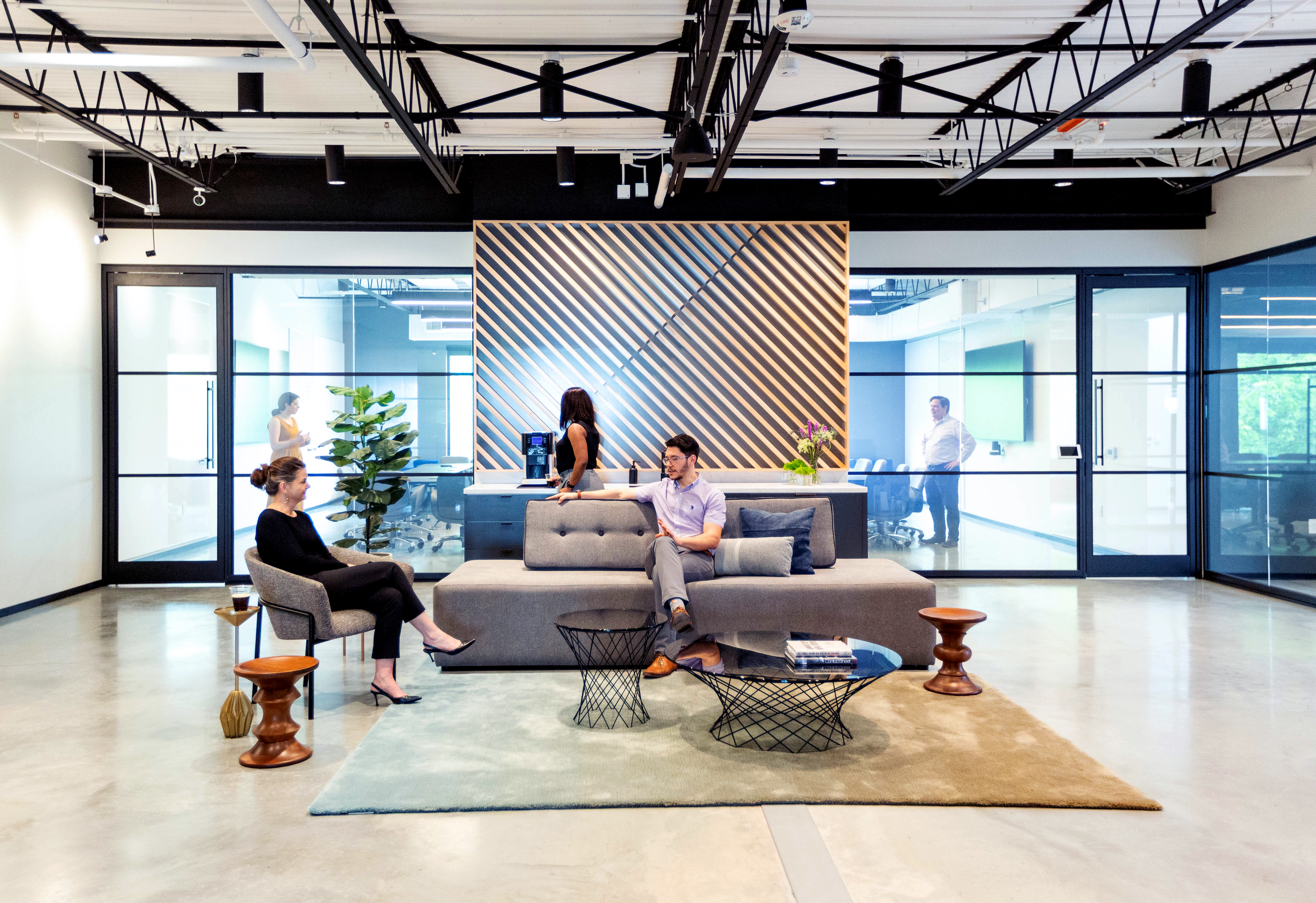 Bright office space with modular glass walls lining the back to let the light in