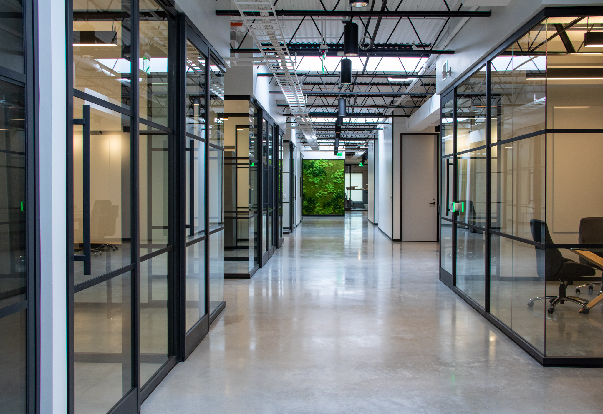 Large office with multiple spaces all built utilizing modular glass wall panels