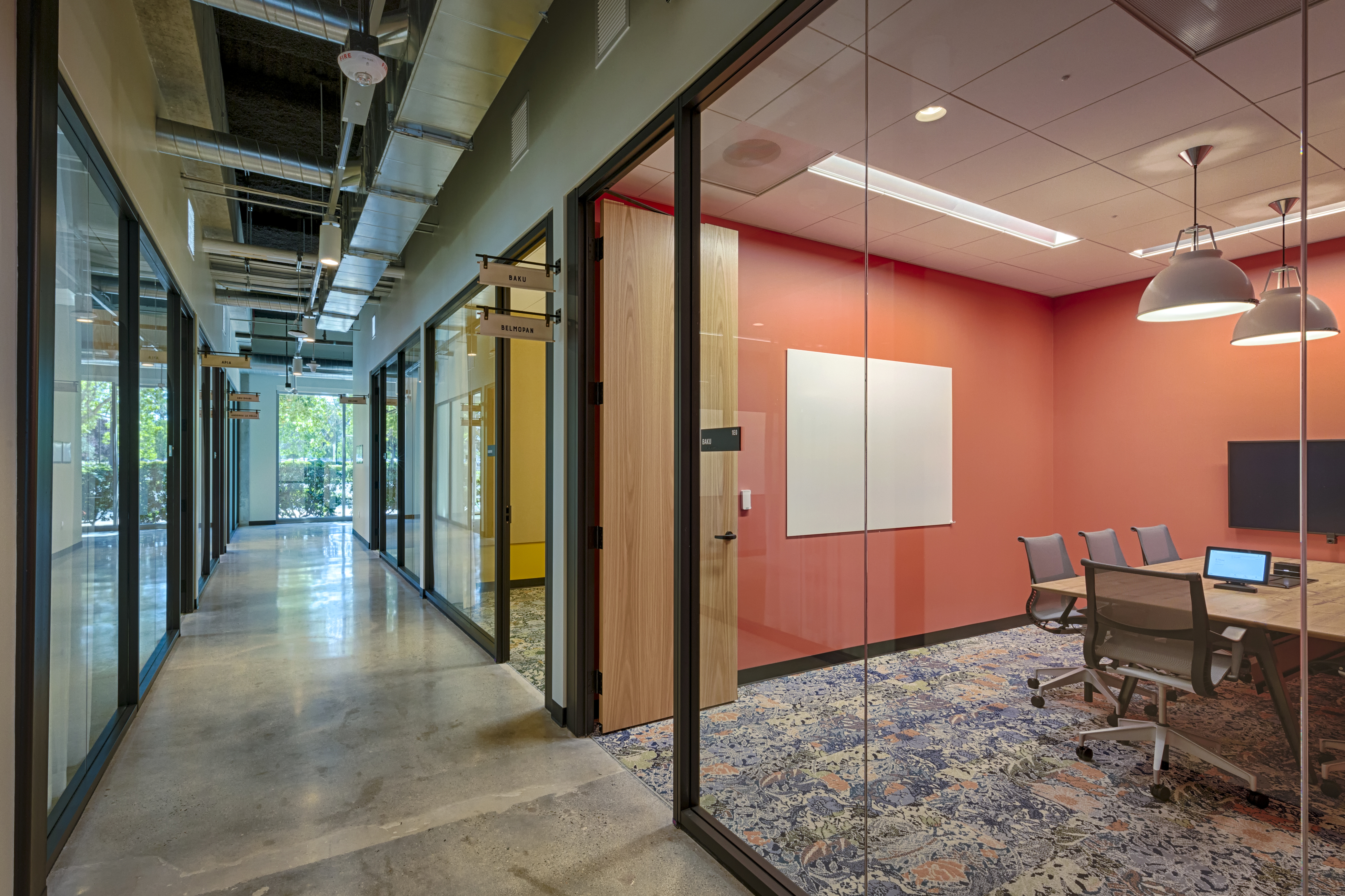 Image of an interior glass wall swinging door