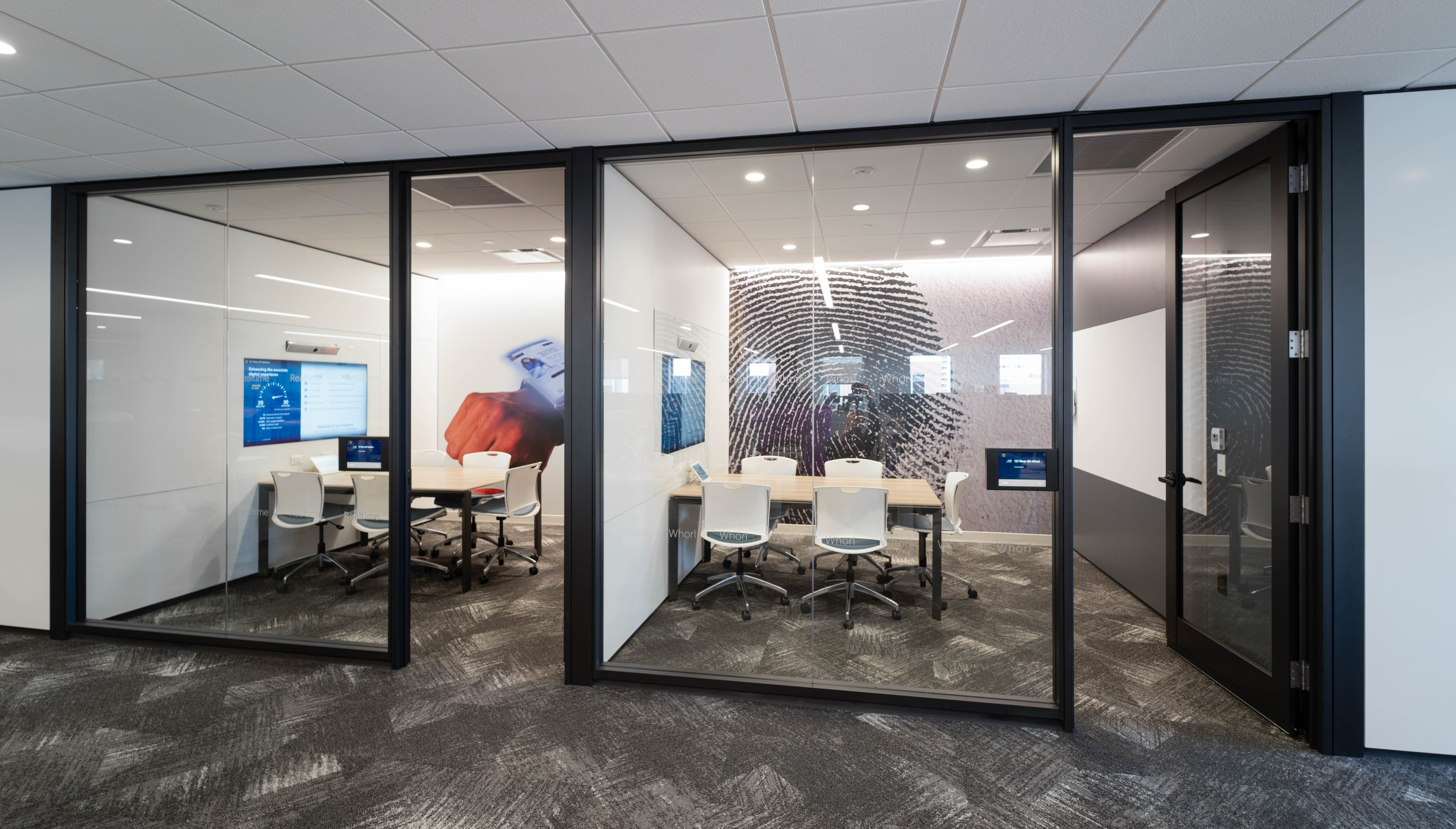 Image of an interior glass wall swinging door with a clean black frame around the exterior