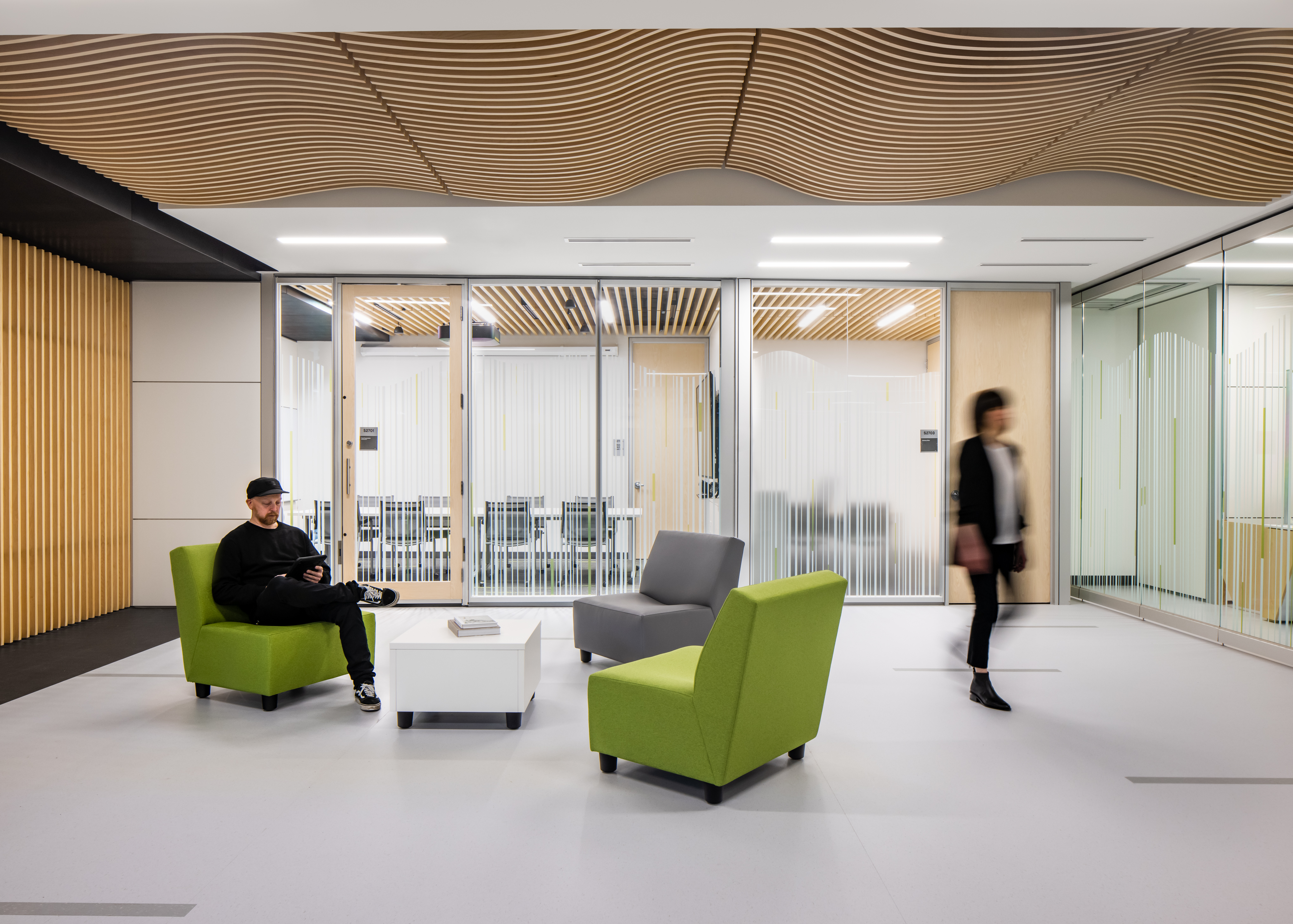 College student centre open space floor plan with swinging glass doors and wall graphics