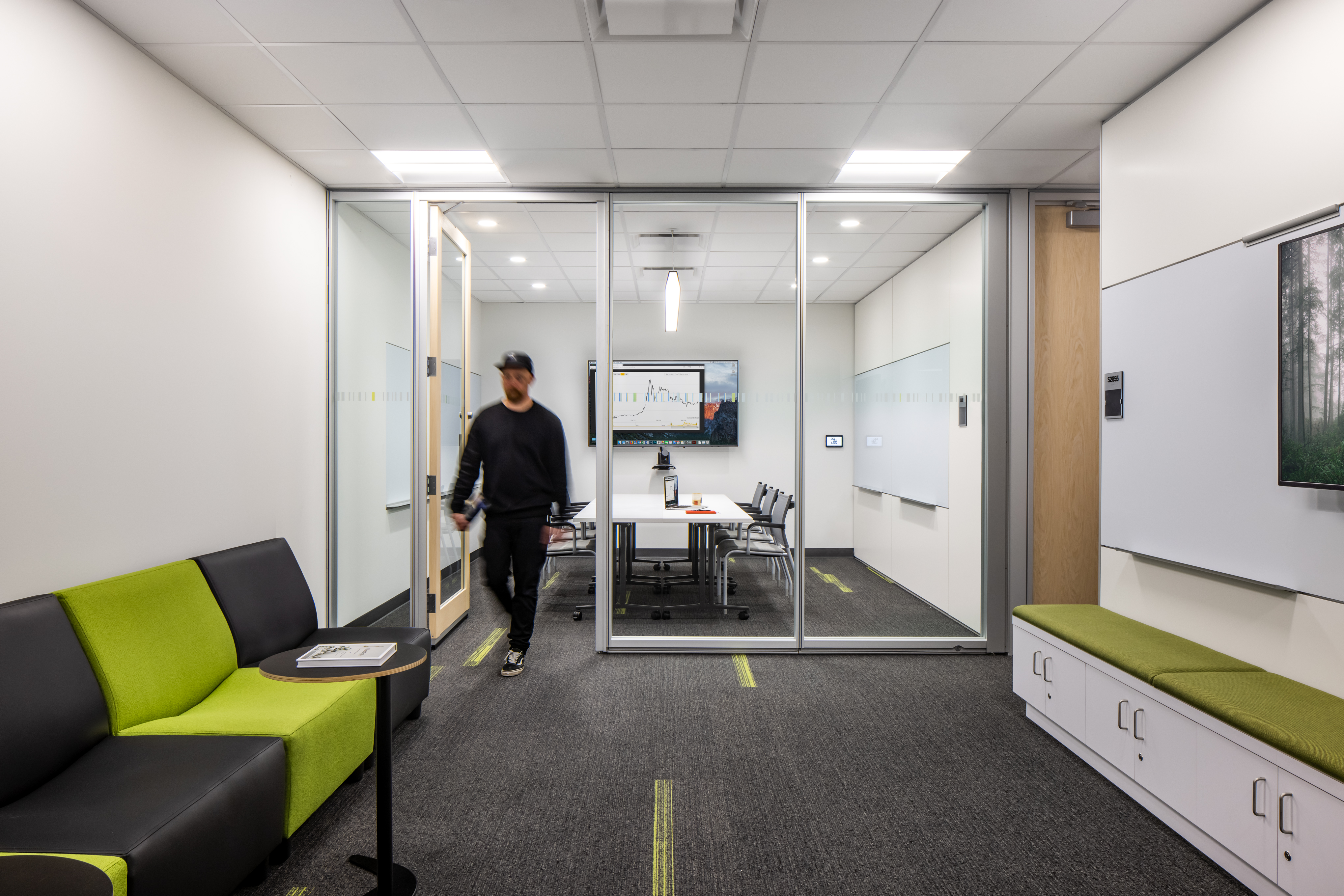 College student centre meeting room with prefab glass swing doors and mounted technology