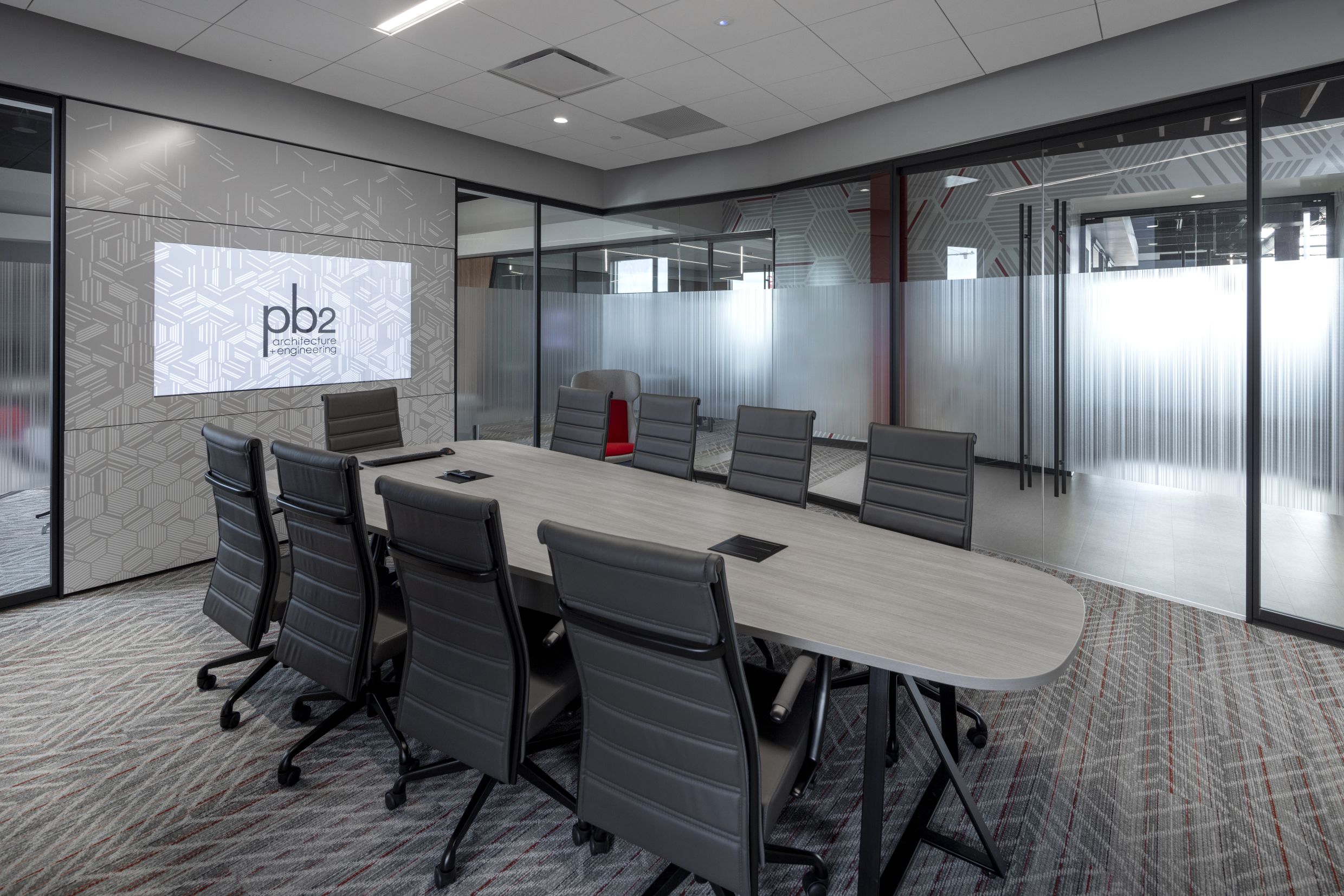 DIRTT project:  pb2 architecture + engineering 4 inch solid wall, center mount glass wall, chromacoat, conference room, custom graphics, glass wall, inspire frameless glass sliding door, inspire glass wall, integrated technology, meeting room, powder coat, pulls, rectilinear, solid integrated display, solid wall